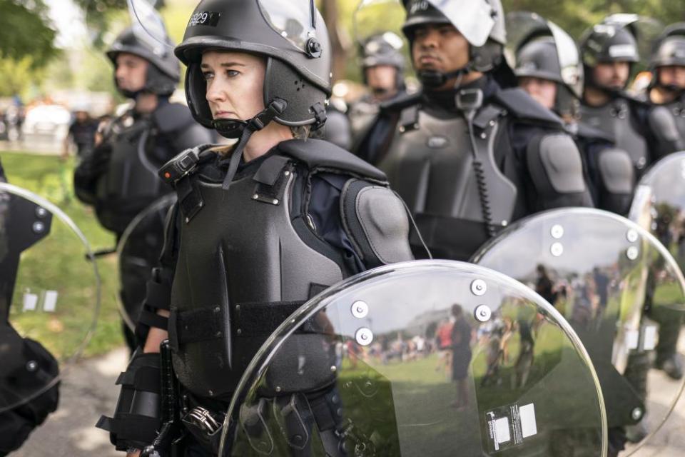 Police in riot gear observe the Justice for J6 rally near the US Capitol in Washington DC on Saturday.