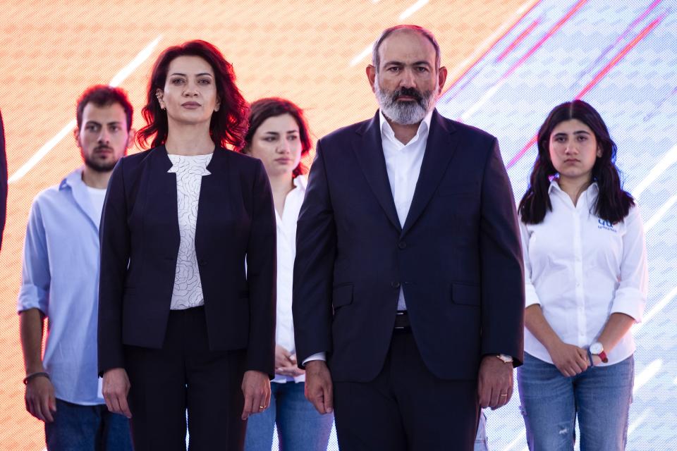 FILE In this file photo taken on Thursday, June 17, 2021, Armenian Prime Minister Nikol Pashinyan and wife Anna Hakobyan attend a rally in his support prior to upcoming parliamentary elections in the center Yerevan, Armenia. Armenians head to the polls Sunday for a snap parliamentary election stemming from a political crisis that has engulfed the former Soviet nation ever since last year's fighting over the separatist region of Nagorno-Karabakh. Acting Prime Minister Nikol Pashinyan called the early vote after facing months of protests demanding his resignation following Armenia's defeat in the Nagorno-Karbakh conflict with Azerbaijan, its neighbor in the Caucasus Mountains region south of Russia.(AP Photo/Areg Balayan, File)