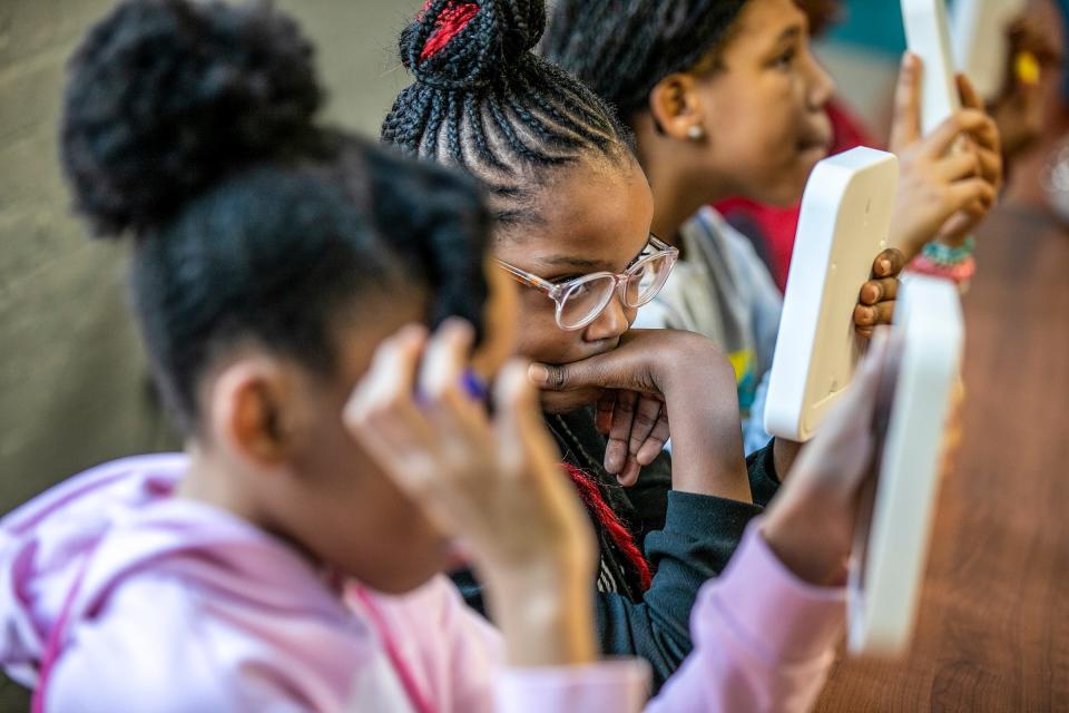 Naviane Maholmes, 9, of Detroit, looks at her reflection in the mirror during a self-love exercise in the Genuinely Loving and Accepting Myself (GLAM) movement class at the Franklin Wright Settlements after-school enrichment program at their Midtown location on Wednesday, Feb. 28, 2024.