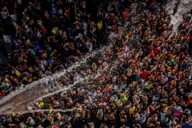 People throw water at each other during the annual water fight in the streets of the Vallecas neighborhood of Madrid, Spain, on Sunday. (Photo: Manu Fernandez / AP)