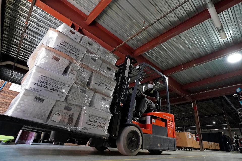 A forklift operator loads absentee ballots for mailing on Sept. 3, 2020, in Raleigh, North Carolina.