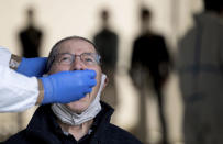 A man gets a coronavirus test at the COVID-19 test station in Stuttgart, Germany, Friday, Oct. 9, 2020. (Marijan Murat/dpa via AP)