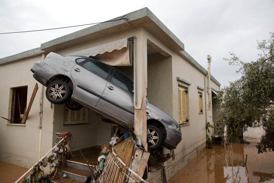 <p>A car at the entrance of a flooded house after the water has receded in the town of Mandra western Athens, on Thursday, Nov. 16, 2017. (Photo: Petros Giannakouris/AP) </p>