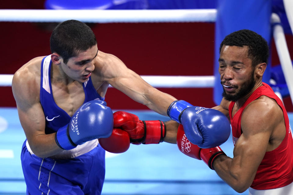 Albert Batyrgaziev, of the Russian Olympic Committee, connects with a punch to Duke Ragan, of the United States, during their final round feather weight 52-57kg final boxing match at the 2020 Summer Olympics, Thursday, Aug. 5, 2021, in Tokyo, Japan. (AP Photo/Frank Franklin II)