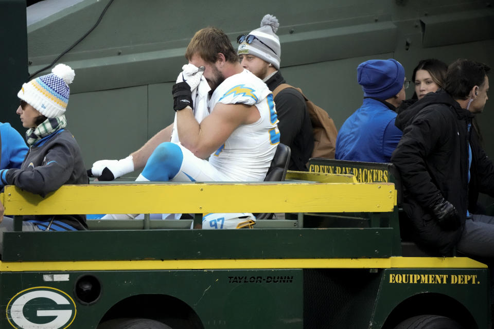 Los Angeles Chargers linebacker Joey Bosa is crated off the field during the first half of an NFL football game against the Green Bay Packers, Sunday, Nov. 19, 2023, in Green Bay, Wis. (AP Photo/Morry Gash)