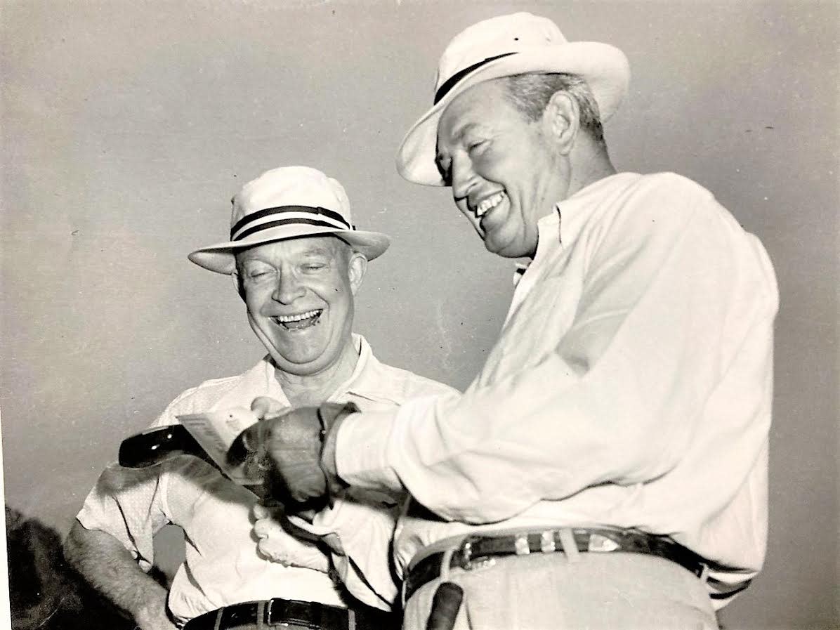 President Eisenhower (left) and Ed Dudley, Augusta National Golf Club pro, are all smiles while checking a scorecard.