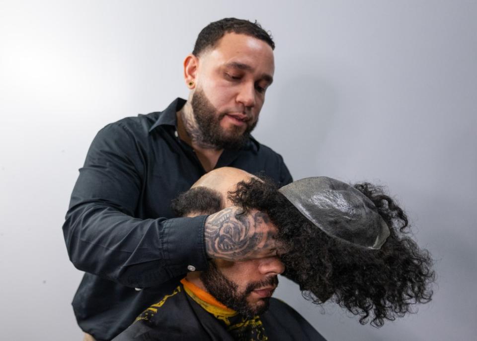 Corey Magnum sat in Hair Replacement Specialist Geraldo Quinones’ chair, where a $1,500 toupee was glued onto his follically-challenged head. J.C. Rice