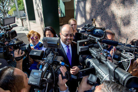 Mexican singer Luis Miguel's lawyer, Kris Demirjian, (C), ignores questions from various news outlets outside the Edward R. Roybal Federal Building in Los Angeles, California, U.S. May 2, 2017. REUTERS/Kyle Grillot