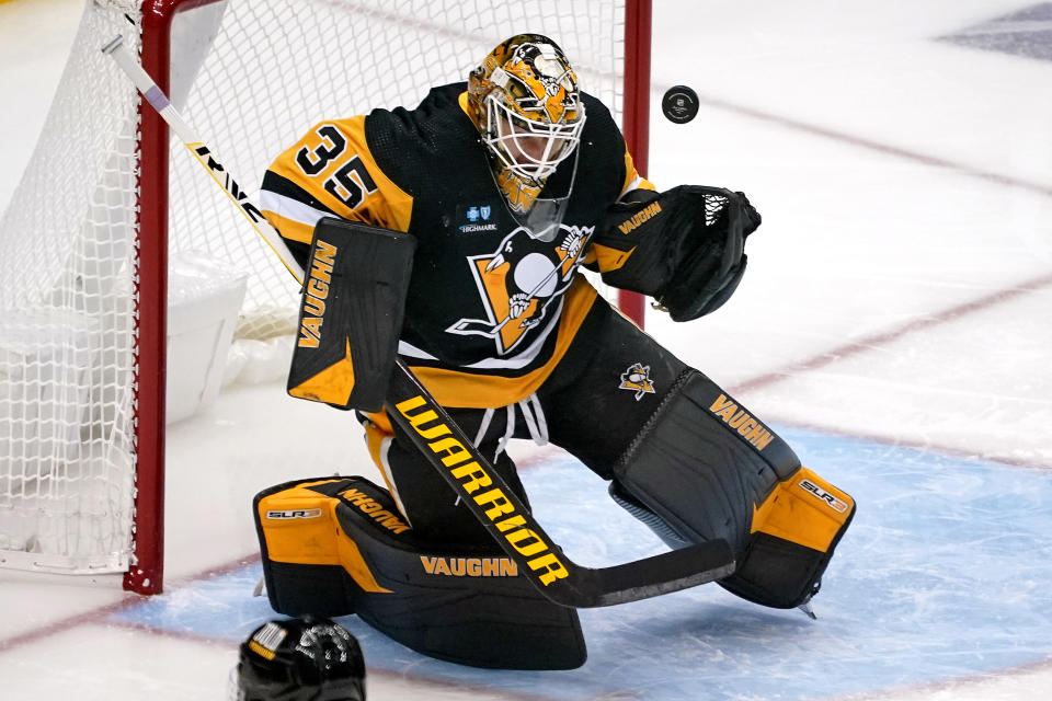 Pittsburgh Penguins goaltender Tristan Jarry blocks a shot during the first period of the team's NHL hockey game against the Calgary Flames in Pittsburgh, Wednesday, Nov. 23, 2022. (AP Photo/Gene J. Puskar)