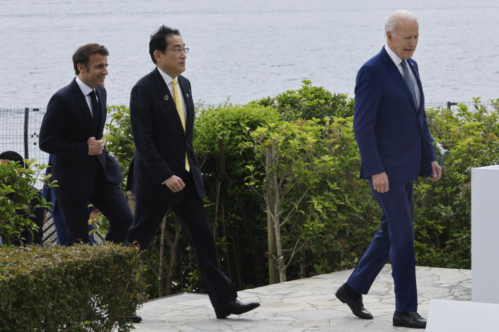 From left, France's President Emmanuel Macron, Japan's Prime Minister Fumio Kishida and U.S. President Joe Biden walk ahead of their working lunch meeting on economic security during the G7 summit, at the Grand Prince Hotel in Hiroshima, western Japan Saturday, May 20, 2023. (Jonathan Ernst/Pool Photo via AP)