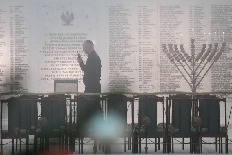 A security guard walks next to a Hanukkah menorah at the Parliament in Warsaw