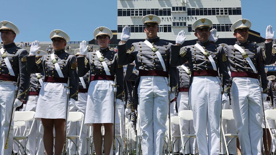 Cadets standing at attention, saluting