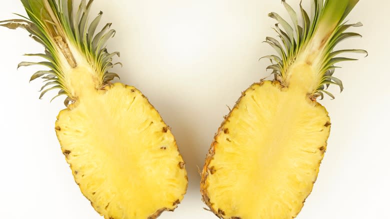 pineapple cut in half on blank table