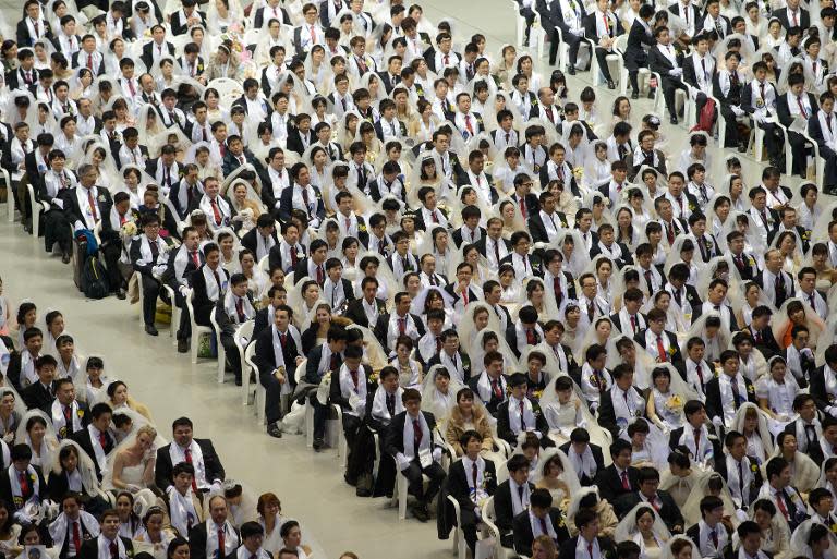 Couples attend a mass wedding at an event held by the Unification Church, in Gapyeong, South Korea, on February 12, 2014