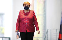 German Chancellor Angela Merkel walks to a media statement after a video conference with mayors of German cities on the spread of the coronavirus disease, in Berlin, Germany, Oct. 9, 2020. (Axel Schmidt/Pool via AP)