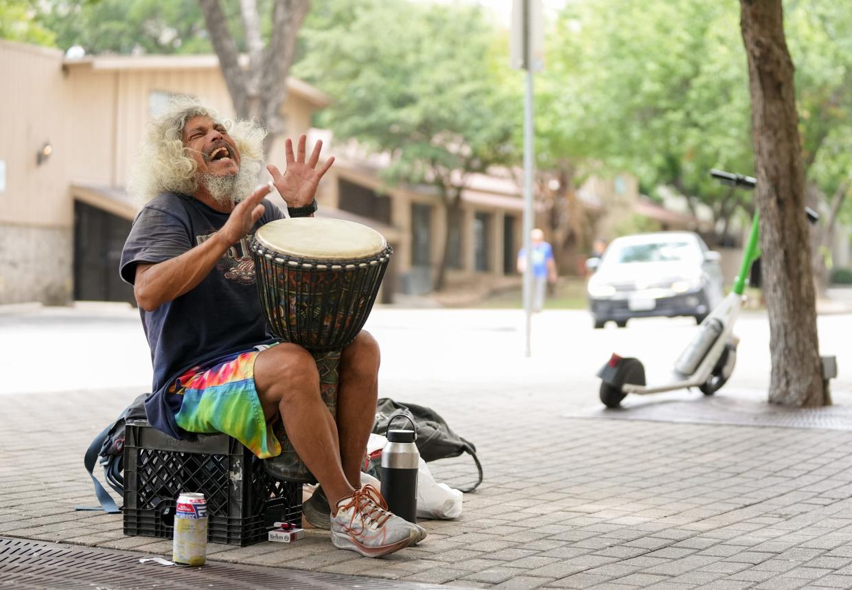 Eric Pounds, affectionately known as Bongo Man, plays a drum on the sidewalk on West 22½ Street in West Campus earlier this month.