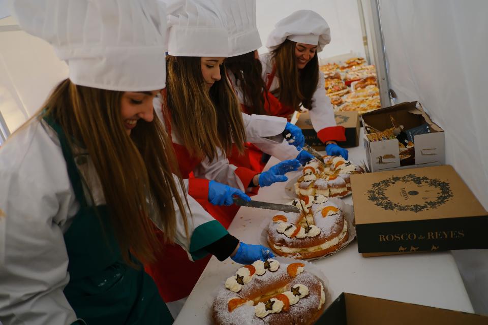 Volunteers prepare to distribute "Rosca de Reyes" cakes, a typical Spanish sponge cake to celebrate the Three Kings' Day, a day before the cavalcade parade in Pamplona, northern Spain, Wednesday, Jan. 4, 2023. The parade symbolizes the coming of the Magi to Bethlehem following the birth of Jesus, marked in Spain and many Latin American countries.