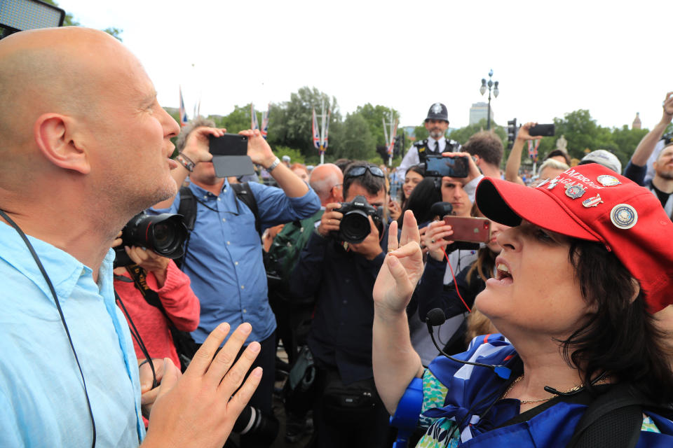 A protester (left) and a Trump supporter exchange views outside Buckingham Palace, London, during the first day of a state visit to the UK by US President Donald Trump.