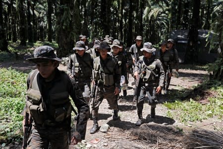 Soldiers patrol during a temporary state of siege, approved by the Guatemalan Congress following the death of several soldiers last week, in the community of Semuy II, Izabal province