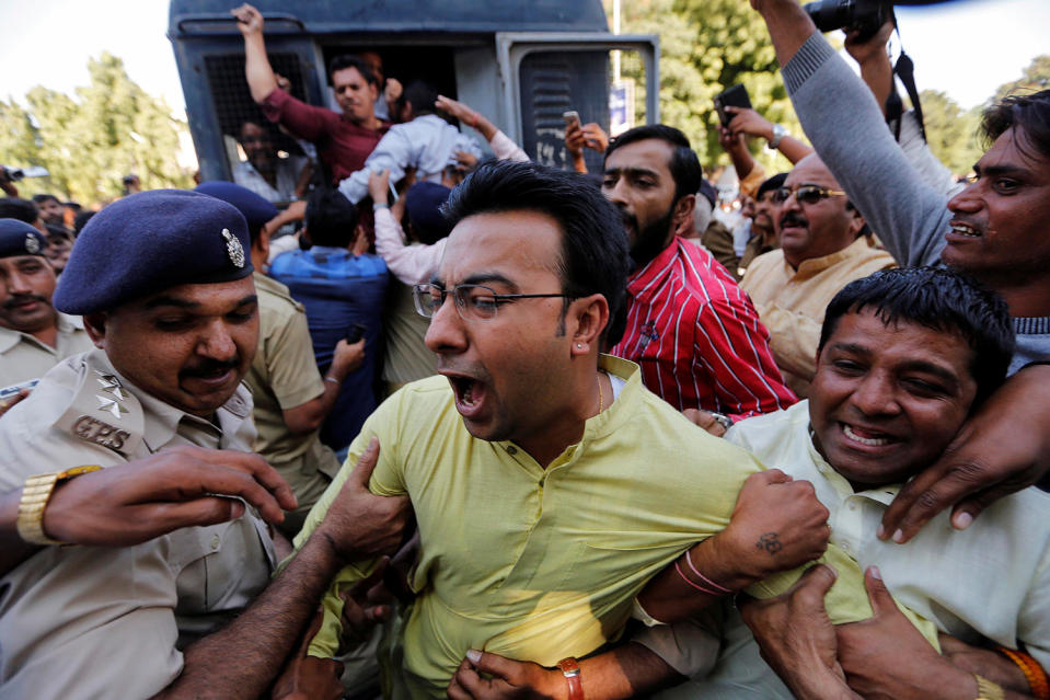 Police detain a supporter of India’s main opposition Congress party