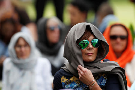 Women wearing headscarves as tribute to the victims of the mosque attacks are seen before Friday prayers at Hagley Park outside Al-Noor mosque in Christchurch, New Zealand March 22, 2019. REUTERS/Jorge Silva