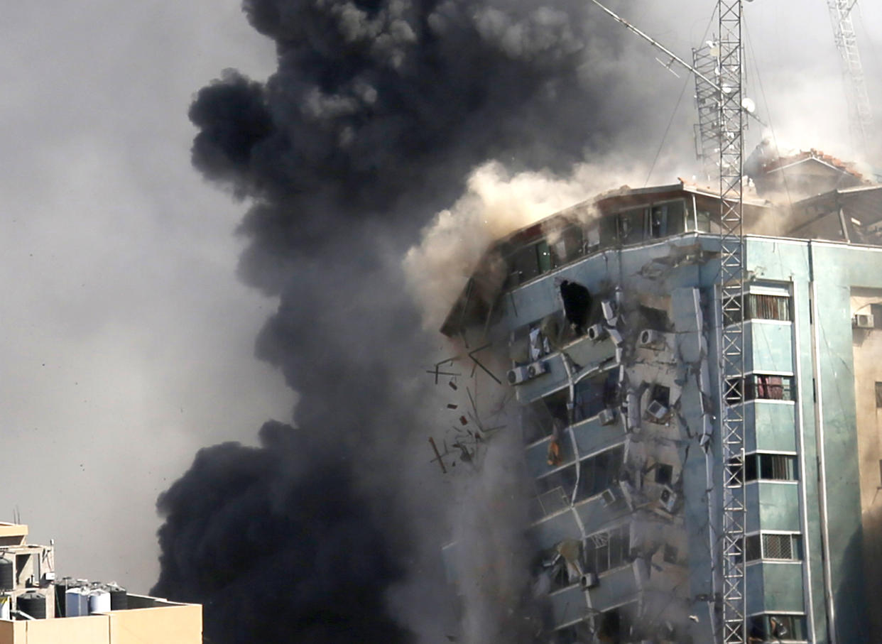 FILE - In this May 15, 2021 file photo, the al-Jalaa building housing the offices of The Associated Press and other media and home to dozens of families, collapses after it was hit by an Israeli airstrike, in Gaza City. The Israeli military says that it made a “mistake” in launching a secretive influence campaign on social media in an effort to improve the public’s view of Israel’s performance in its devastating war with Gaza militants in 2021. The online campaign, which failed to gain traction, was one of several contentious — even deceptive — tactics employed by the Israeli military in the bloody 11-day war, which killed over 260 Palestinians and 13 Israelis, as the military bombed the Hamas-ruled territory and Palestinian militants launched rockets at Israel. (AP Photo/Hatem Moussa, File)