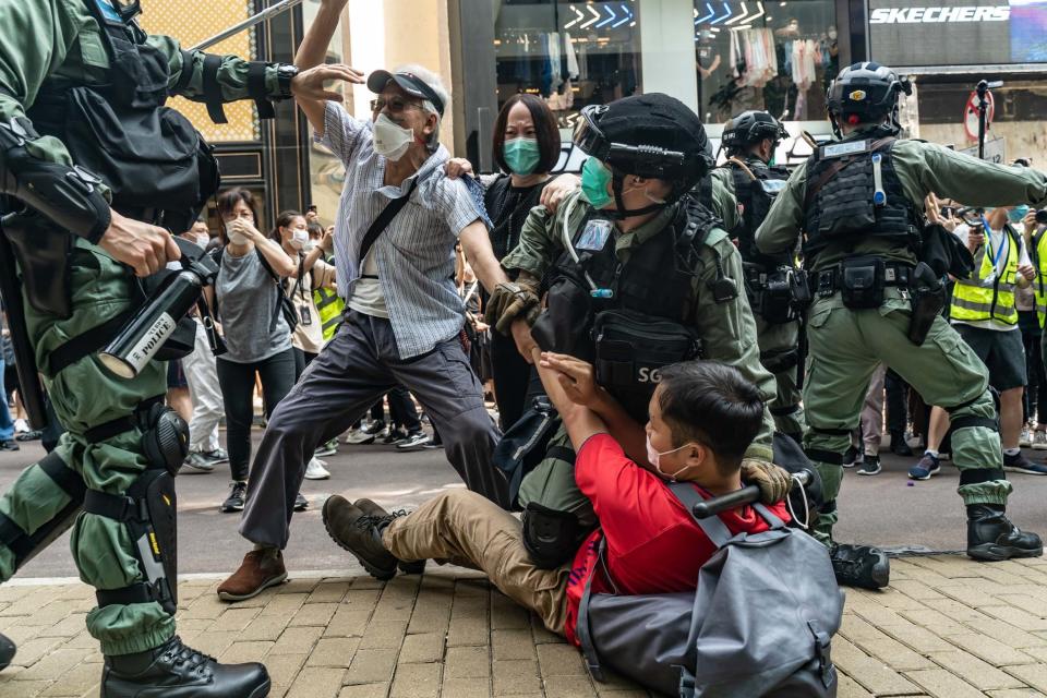 Pro-democracy supporters scuffle with riot police during a rally in Causeway Bay district on May 27 (Getty Images)