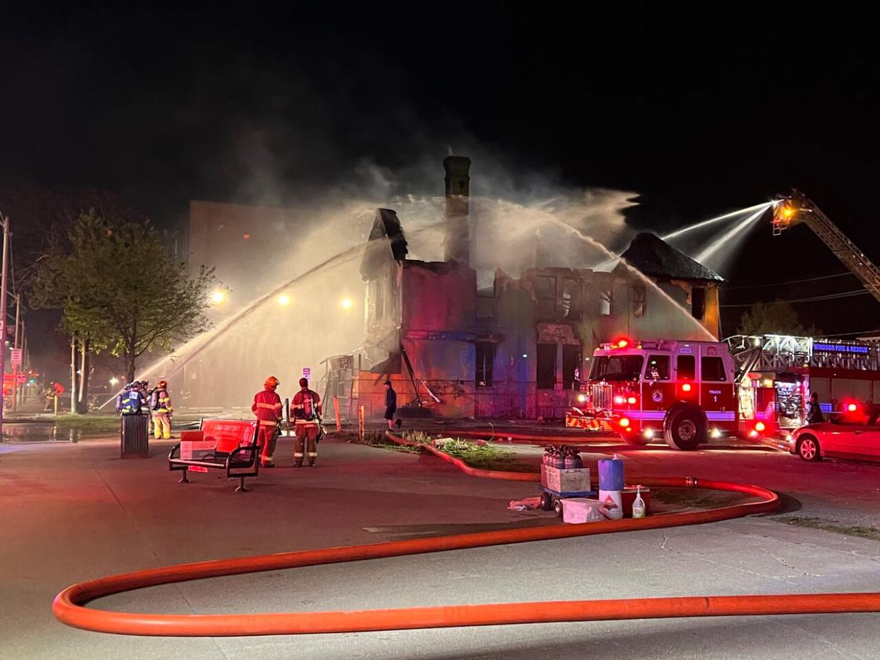 Fire crews fight a blaze at an abandoned spray-painted building in Windsor's downtown. (Jacob Barker/CBC - image credit)