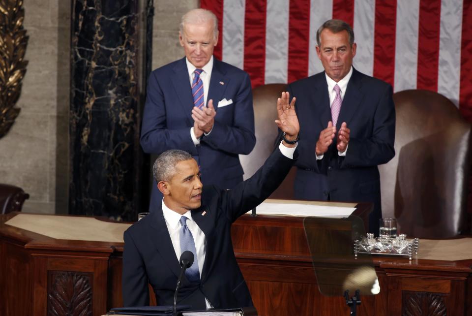 U.S. Vice President Biden and Speaker of the House Boehner applaud as U.S. President Obama waves before delivering his State of the Union address to a joint session of the U.S. Congress on Capitol Hill in Washington