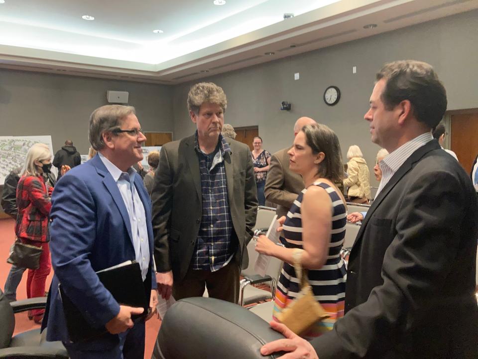 Scott Busby and Gregor Smee with Smee Busby, the architecture firm working with Cappiello Real Estate, talk to Jessica and Joshua Wright with Machinations after a meeting of the Oak Ridge Land Bank. The Land Bank board approved a resolution that supports their firms working on new buildings near Wilson Street in Oak Ridge.