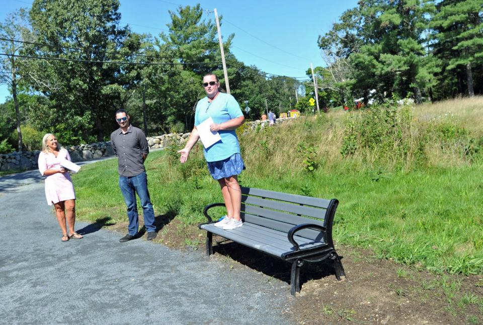 Norwell Conservation Commission Chair Marynel Wahl, right, talks about the dedication of a garden in memory of the town's late conservation agent, Nancy Hemingway, as beautification committee member Sarah Baker, left, and Conservation Agent Will Saunders, center, look on.