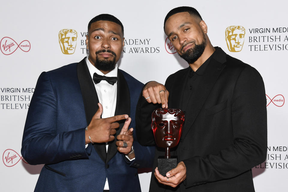 Jordan Banjo, left, and Ashley Banjo pose for photographers with their Must See Moment award in 'Britain's Got Talent' backstage at the British Academy Television Awards in London, Sunday, June 6, 2021. (AP Photo/Alberto Pezzali)