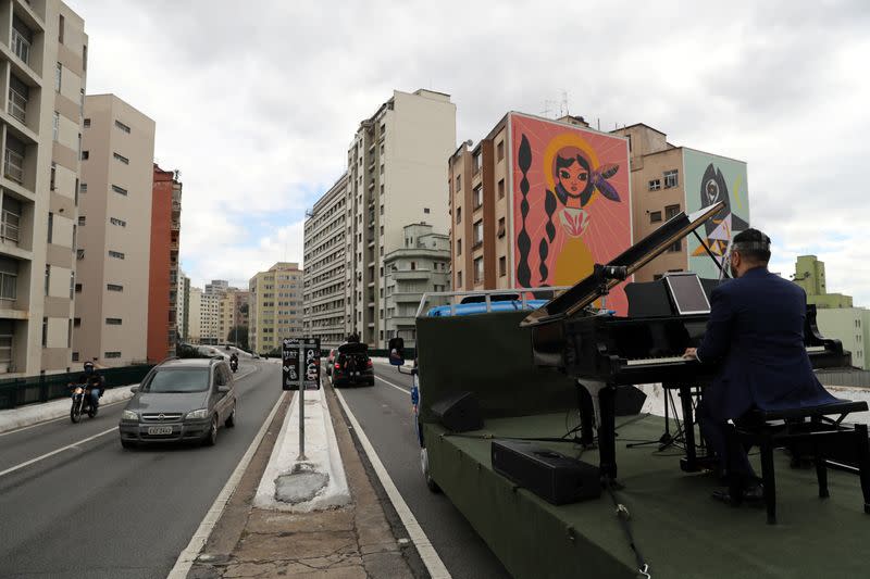 Pianist Rodrigo Cunha serenades from an open truck, in Sao Paulo