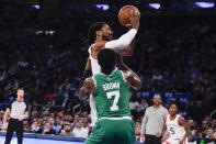 New York Knicks' Derrick Rose (4) shoots over Boston Celtics' Jaylen Brown (7) during the first half of an NBA basketball game Wednesday, Oct. 20, 2021, in New York. (AP Photo/Frank Franklin II)