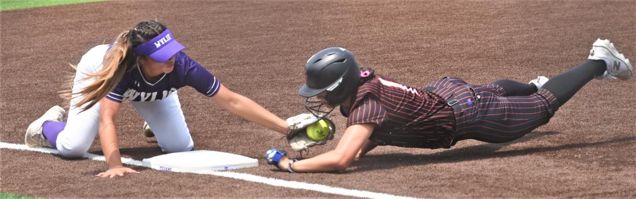 Wylie shortstop Kat Martinez, left, tags out Aledo's Macy Graf, who was trying to steal third base in the first inning.