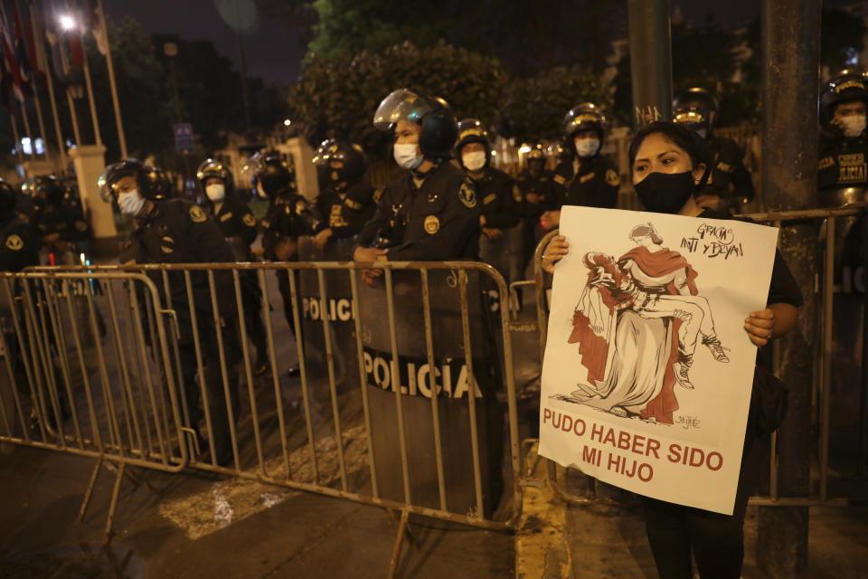 A woman holds a sign that reads in Spanish "It could have been my son" a she joins a protest agains impunity and for a constiturional reform, after Francisco Sagasti was sworn-in as the new interim president in Lima, Peru, Tuesday, Nov. 17, 2020. Sagasti's appointment marks a tumultuous week in which thousands took to the streets outraged by Congress' decision to oust popular ex-President Martín Vizcarra. (AP Photo/Rodrigo Abd)