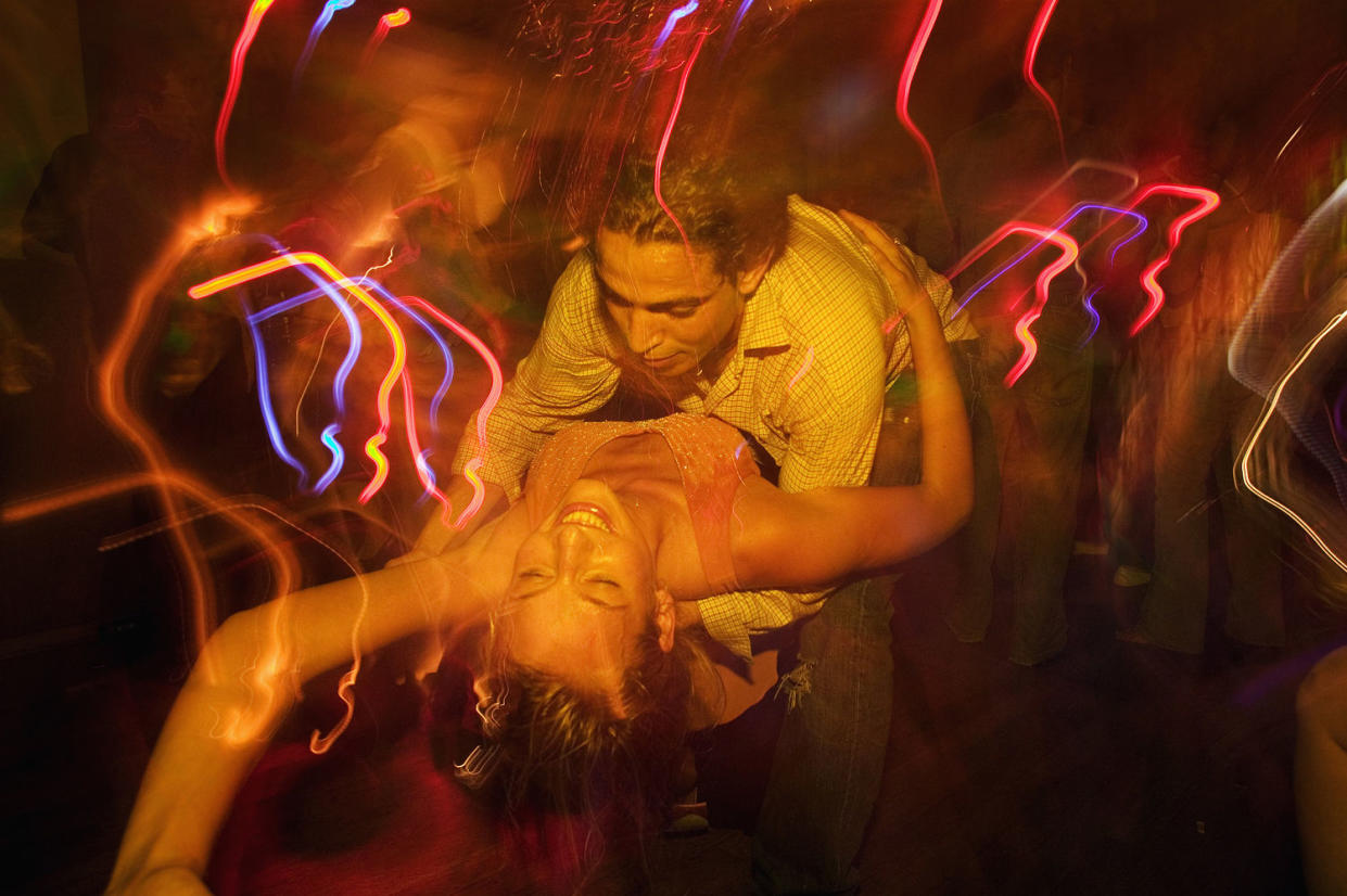 Couple dancing together in nightclub (Sven Hagolani / Getty Images/fStop)