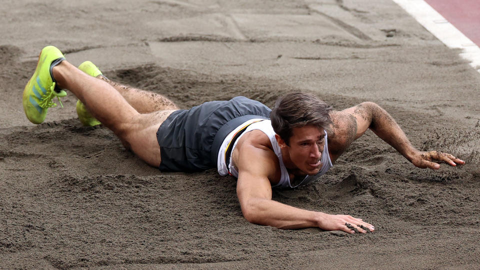 Belgian Thomas Van Der Plaetsen lies injured on the ground during the long jump contest. (Photo by BENOIT DOPPAGNE/BELGA MAG/AFP via Getty Images)