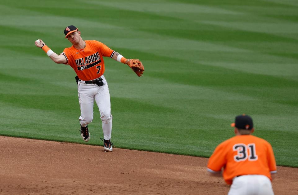 Oklahoma State utility Roc Riggio (7) throws to first base for an out during a college baseball game between the Oklahoma State Cowboys and the Oklahoma Sooners at OÕBrate Stadium in Stillwater, Okla., on Tuesday, April 18, 2023.