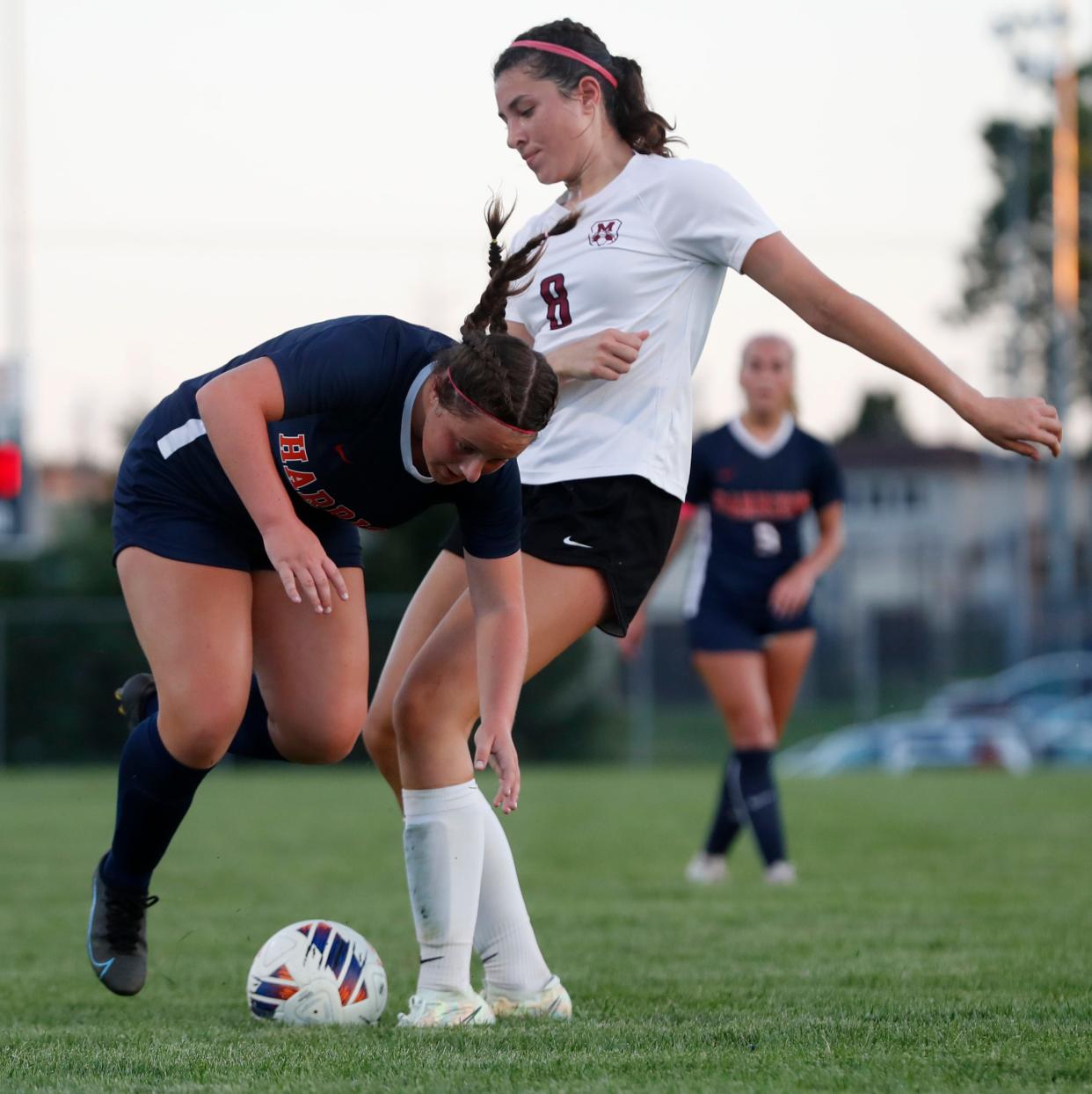 Harrison defender Josey Hall (17) and McCutcheon defender Kalea Washington (08) fight for the ball during the IHSAA girls soccer game, Wednesday, Aug. 31, 2022, at Harrison High School in West Lafayette, Ind.