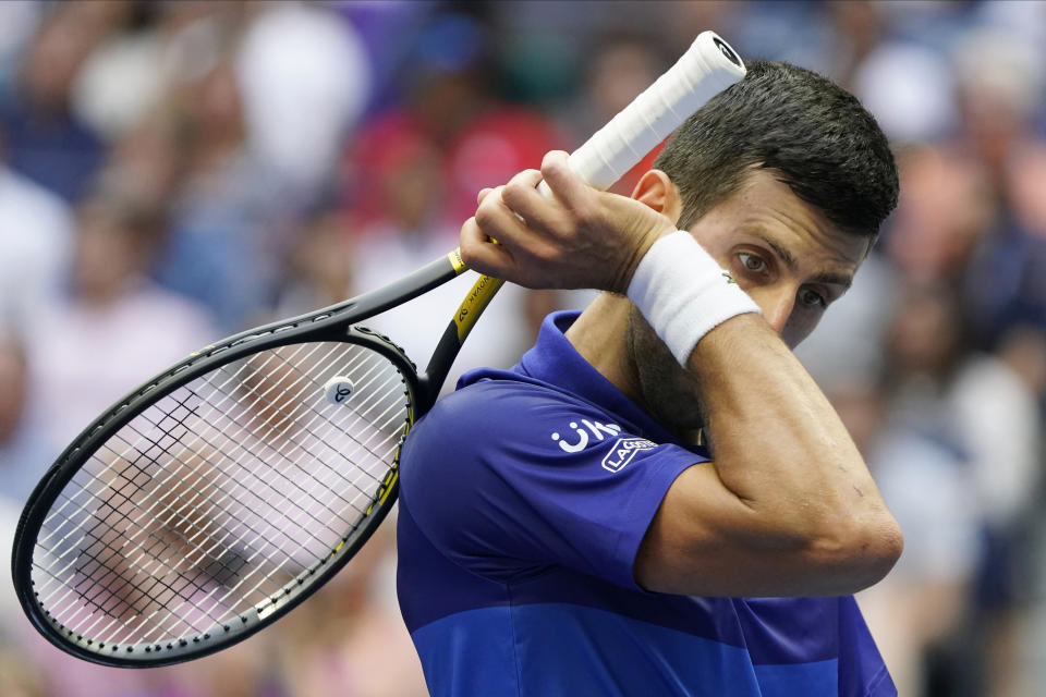 Novak Djokovic, of Serbia, wipes sweat from his face between points during the men's singles final of the US Open tennis championships against Daniil Medvedev, of Russia, Sunday, Sept. 12, 2021, in New York. (AP Photo/John Minchillo)