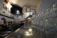 A bartender drafts a beer at a pub in Prague, Czech Republic, Thursday, Dec. 3, 2020. A sign of normalcy has returned to the Czech Republic ahead of the Christmas period after the government eased some of its most restrictive measures imposed to contain the recent massive surge of coronavirus infections. On Thursday all stores, shopping malls, restaurants, bars and hotels were allowed to reopen. (AP Photo/Petr David Josek)