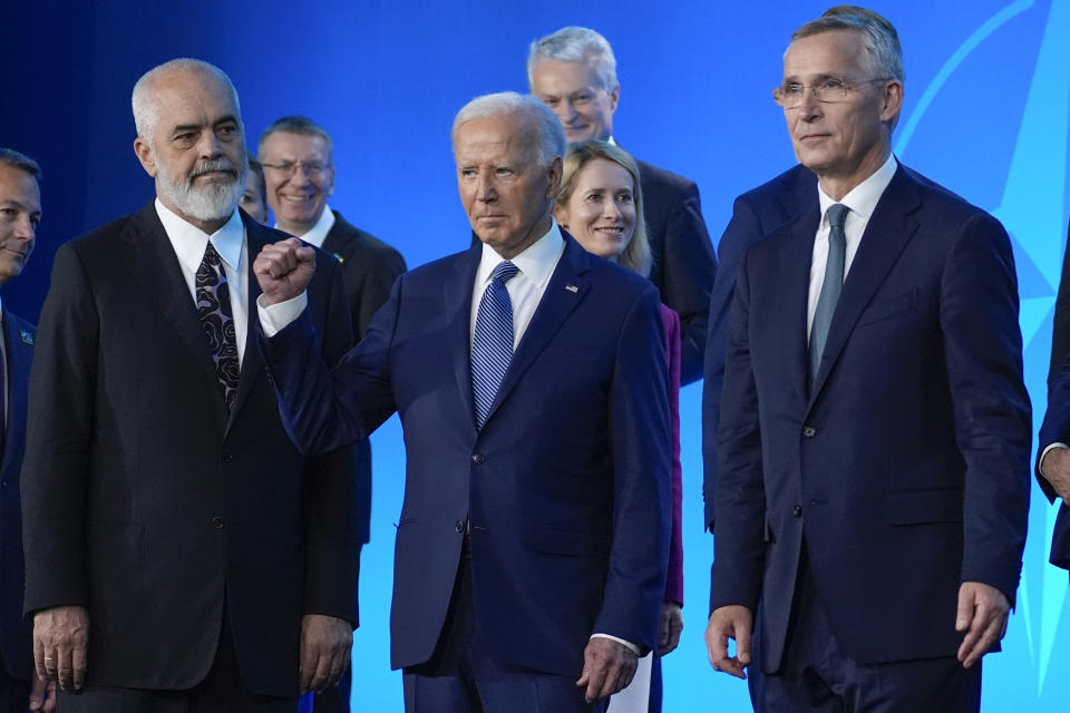 President Joe Biden, center, gestures with Albania's Prime Minister Edi Rama, left, and NATO Secretary General Jens Stoltenberg, right, after a family photo at the NATO Summit, Wednesday, July 10, 2024, in Washington. (AP Photo/Evan Vucci)