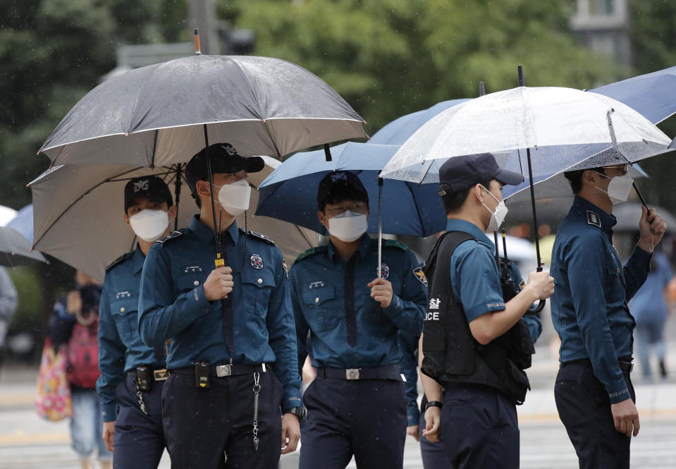 Police officers wearing face masks to help protect against the spread of the coronavirus, walk in downtown Seoul, South Korea, Monday, Sept. 7, 2020. (AP Photo/Lee Jin-man)