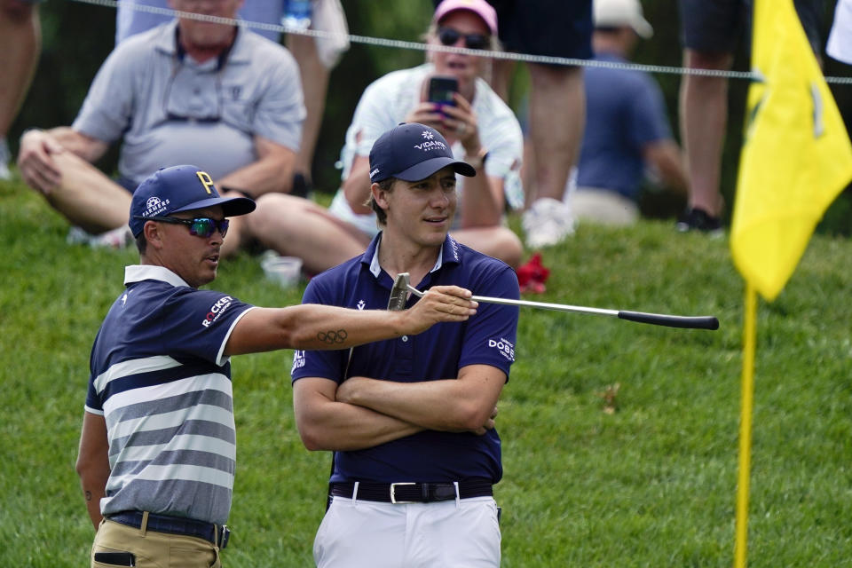 Rickie Fowler, left, talks with Carlos Ortiz, of Mexico, on the 10th green during the third round of the Memorial golf tournament, Saturday, June 5, 2021, in Dublin, Ohio. (AP Photo/Darron Cummings)