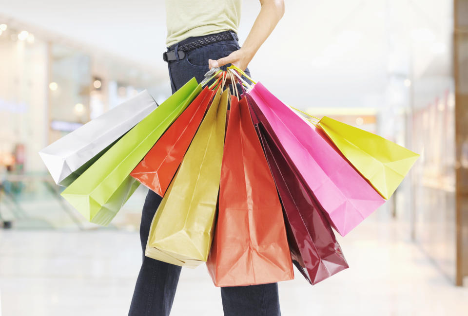 person carrying a bunch of shopping bags