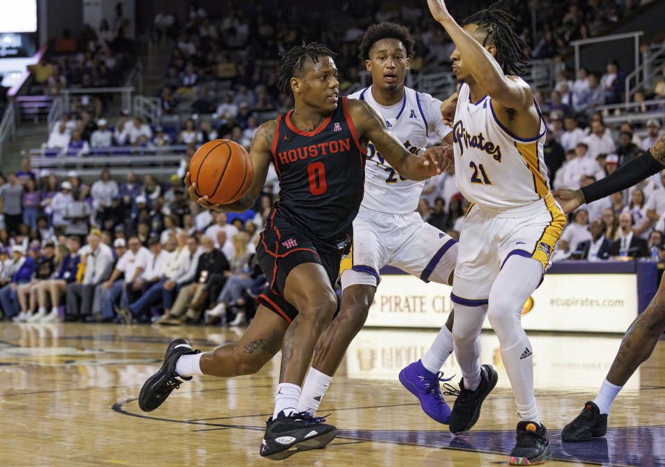 Houston's Marcus Sasser (0) drives against East Carolina's Jaden Walker (21) during the second half of an NCAA college basketball game in Greenville, N.C., Saturday, Feb. 25, 2023. (AP Photo/Ben McKeown)