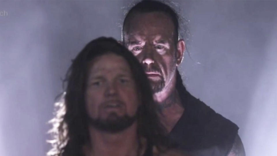The Undertaker stares at AJ Styles ready to surprise him during WrestleMania.