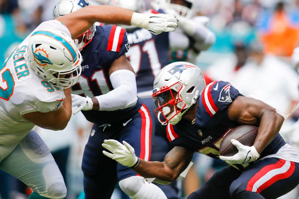 Dolphins defensive tackle Zach Sieler tries to get to Patriots running back Damien Harris during last Sunday's game at Hard Rock Stadium.