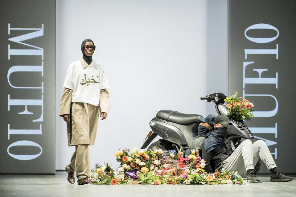 CAPTION CORRECTS THE GARMENTS - Models display creations by Iranian born designer Reza Etamadi during a MUF10 fashion show in Copenhagen, Wednesday, Aug. 8, 2018. An Iranian-born fashion designer has stolen the limelight at a fashion show when showcasing models in niqabs and dressed as police officers appeared on the catwalk as part of his collection themed around women wearing face veil, days after a new law banning such garments in public places entered into force. (Mads Claus Rasmussen/Ritzau Scanpix via AP)